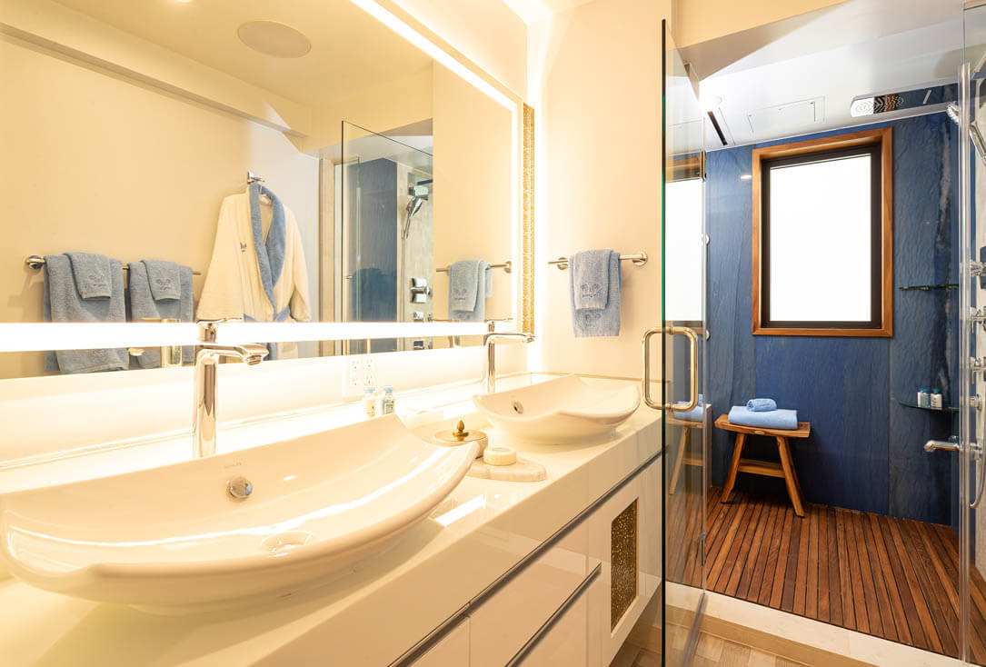 Bathroom with 2 sinks and marble shower.