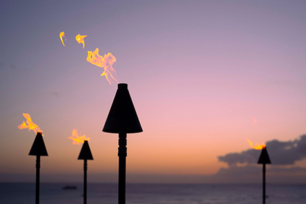 Torches with a sunset behind it
